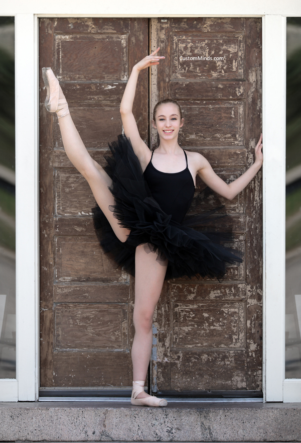 Ballerina poses by door