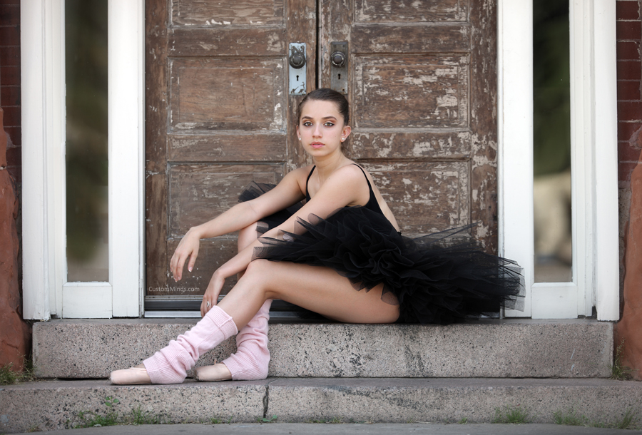 Ballerina poses by doors
