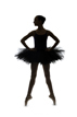 Ballerina poses in studio with a silhouette