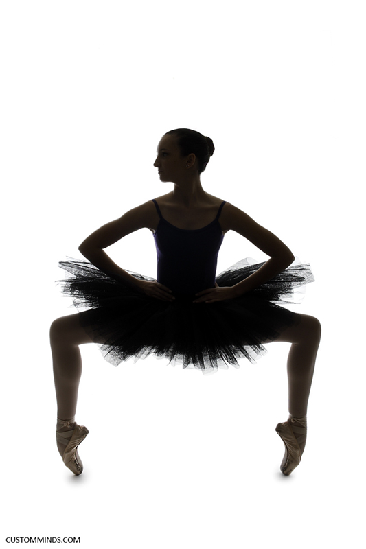 Ballerina poses in studio with a silhouette
