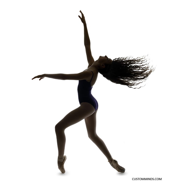 Ballerina poses in studio with a silhouette with hair thrown back
