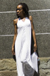 white dress by a concrete wall in tokyo japan