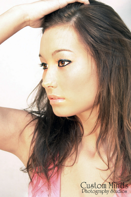 headshot holding hair up in the studio