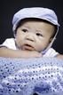 baby with blue blanket and hat