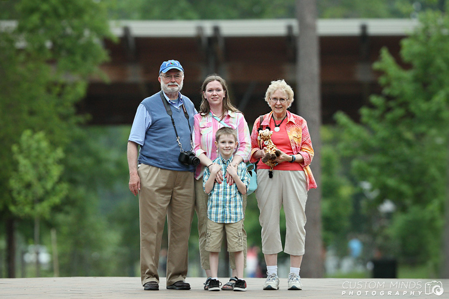family outside the houston zoo entrance by hermann park in houston texas
