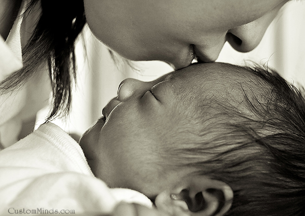 mother kisses baby