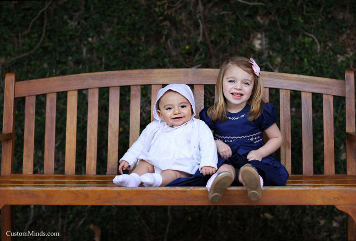 children sit on park bench