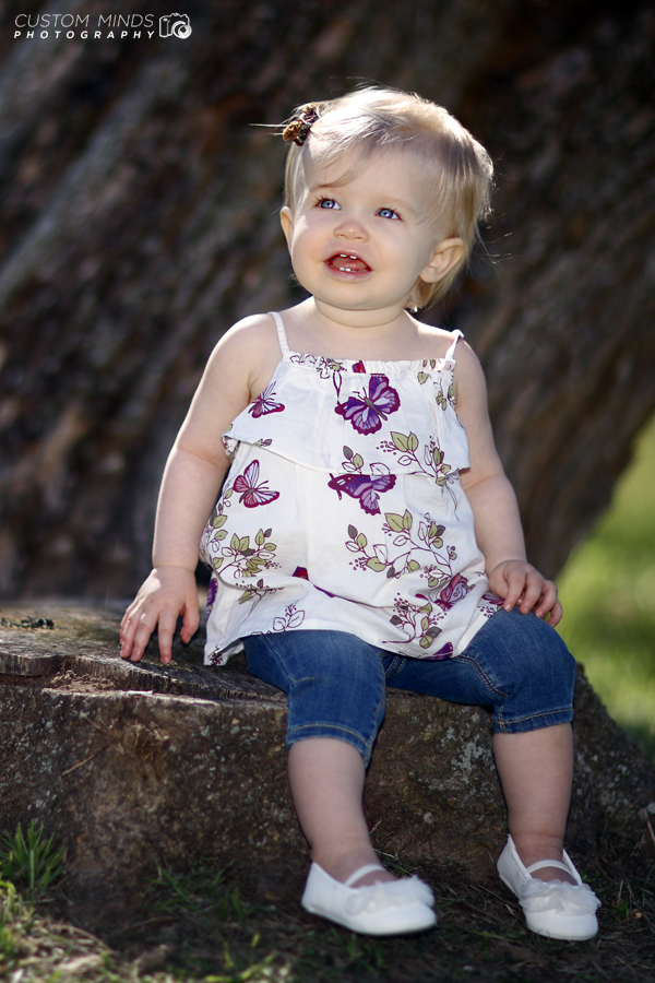 child sitting on a stump