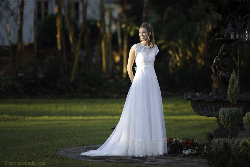 Smiling bride by fountain at Oak Tree Manor Bed and Breakfast  in Spring Texas