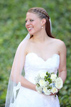 Bride posing by a patch of greenery by the Houston Grand Opera