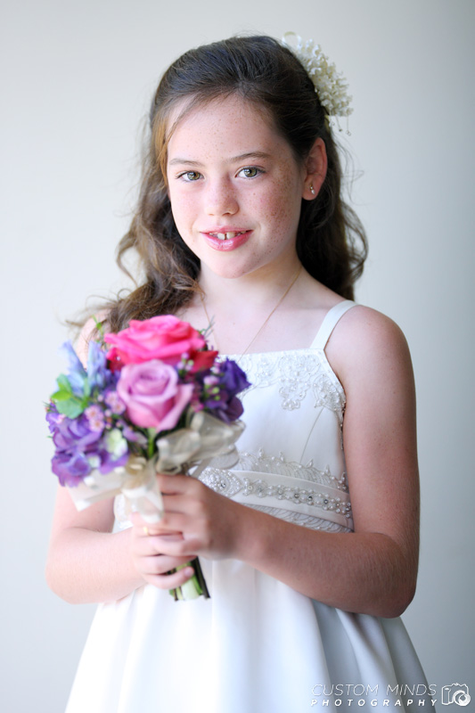 flower girl smiles as her portrait is taken