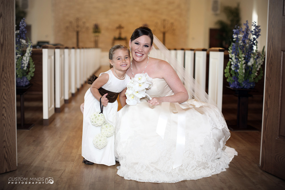 Bride and flower girl with big smiles