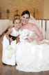 Bride and flower girl with big smiles