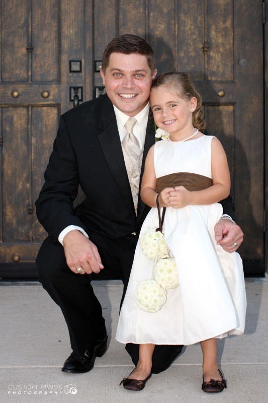 Groom and flower girl with big smiles