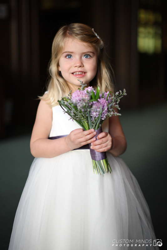 Flowergirl smile and holds flowers in Houston Texas
