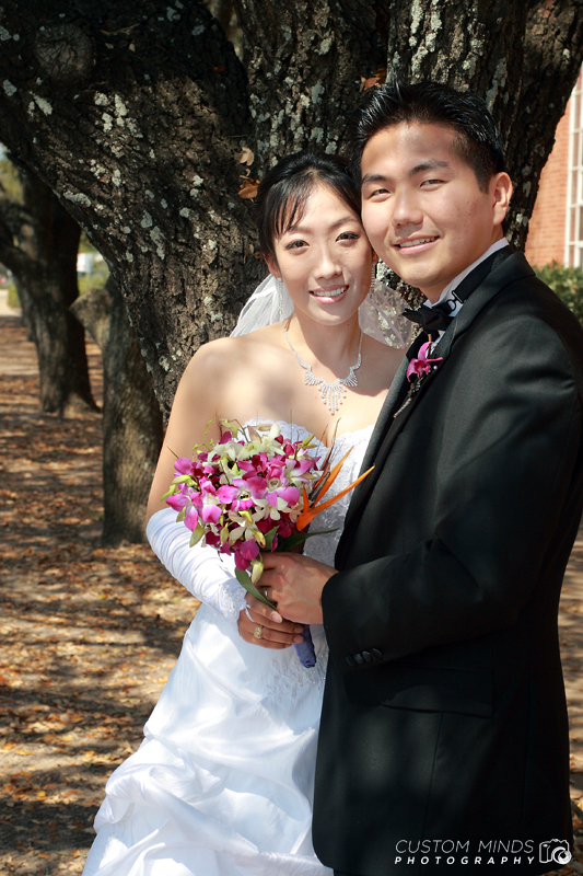 Bride and Groom posing with bouquet in Bryan College Station Texas