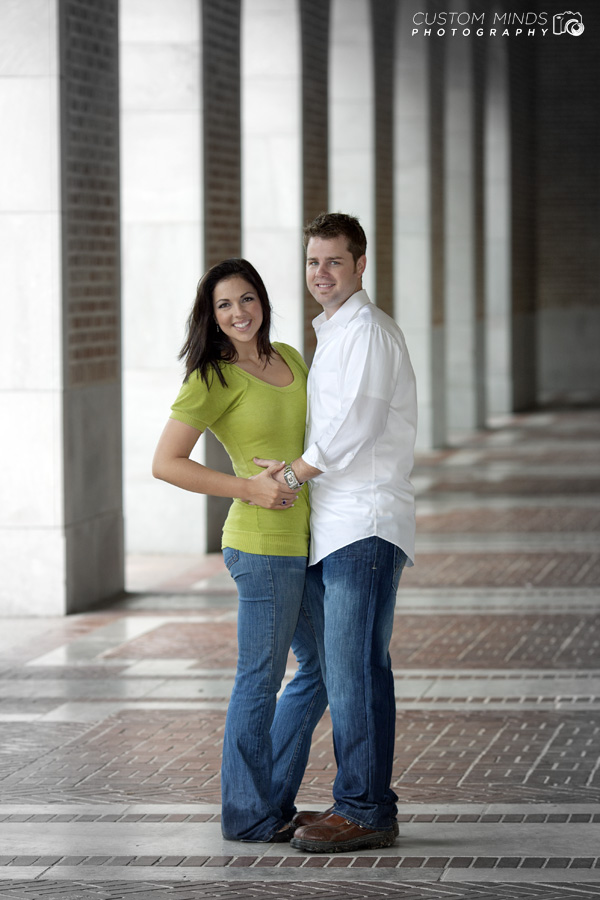 standing in the hallway during an engagement session at Rice University