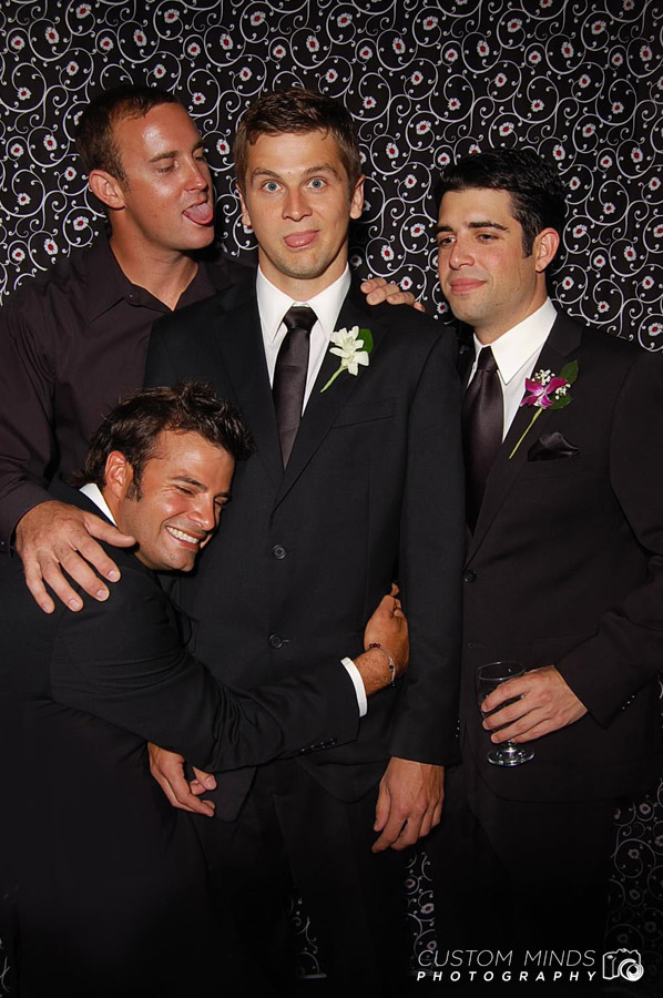 Groom and groomsmen joking around in out Katy Texas photo booth