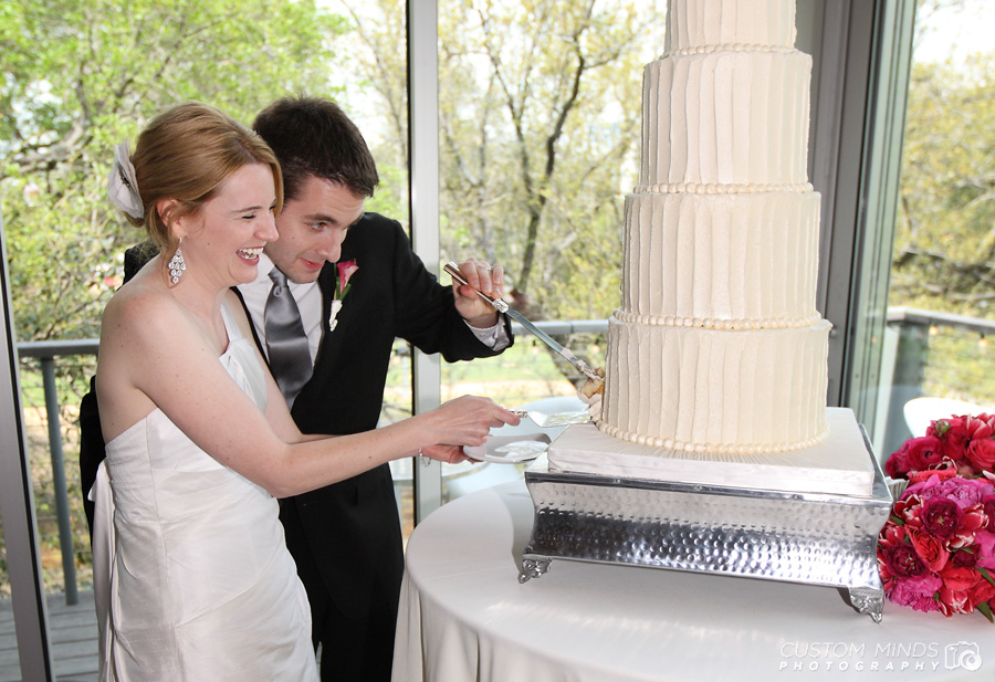 bride and Groom cut their Wedding cake at The Grove by Discovery Green Park in Houston Texas